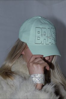 Light green cap showing outline style BRASH lettering with sketch line elements
